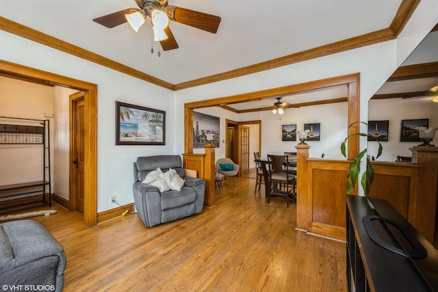 living room featuring light wood-type flooring and ornamental molding