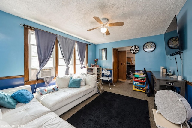 living room featuring carpet flooring, ceiling fan, cooling unit, and a textured ceiling