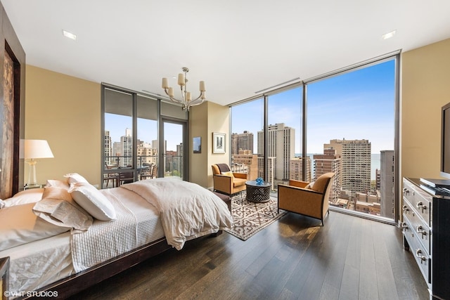 bedroom featuring a notable chandelier, dark hardwood / wood-style floors, and multiple windows