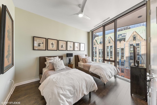 bedroom with floor to ceiling windows, dark wood-type flooring, and ceiling fan