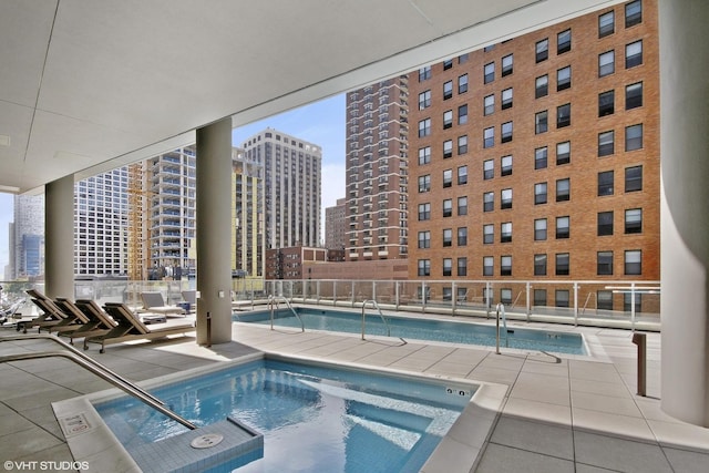 view of pool featuring a patio and a hot tub