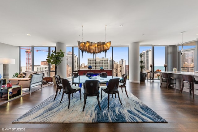 dining space featuring expansive windows, dark wood-type flooring, and an inviting chandelier