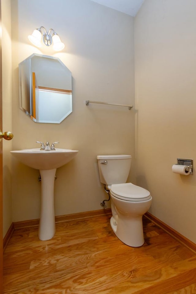 bathroom featuring toilet and hardwood / wood-style flooring