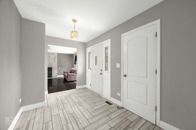 entrance foyer with a tiled fireplace