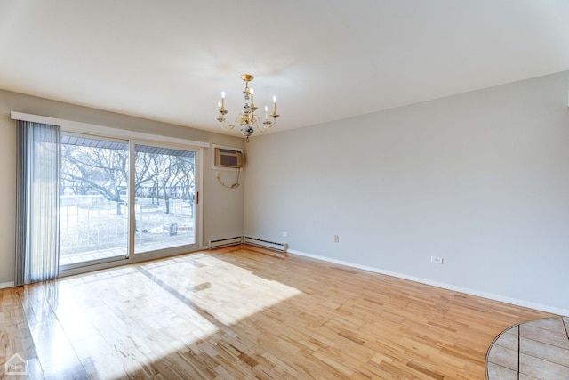 empty room featuring a baseboard radiator, a chandelier, and light hardwood / wood-style flooring