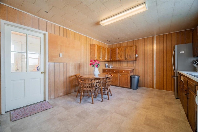 dining area featuring wooden walls