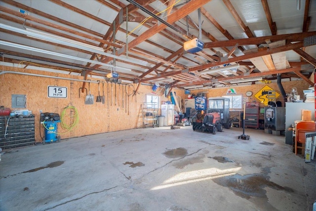 garage with electric panel and a garage door opener