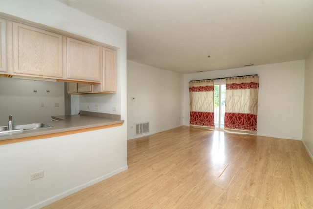 kitchen featuring sink, light brown cabinetry, and light hardwood / wood-style flooring