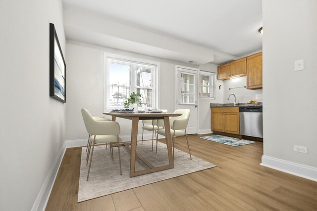 dining space featuring light hardwood / wood-style flooring and sink