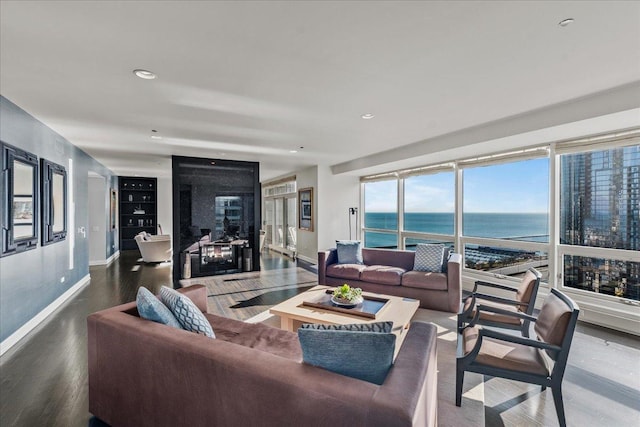 living room featuring hardwood / wood-style floors and a water view