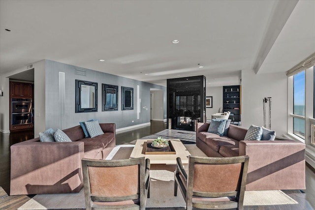 living room with hardwood / wood-style floors and a fireplace