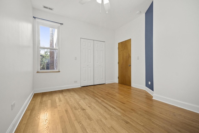 unfurnished bedroom featuring ceiling fan, a closet, and light hardwood / wood-style flooring