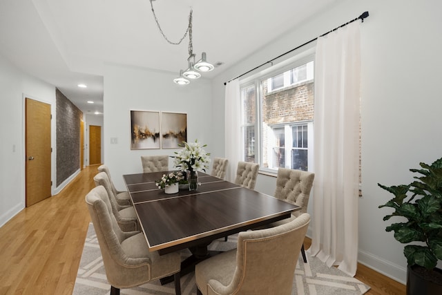 dining room featuring an inviting chandelier and light hardwood / wood-style flooring