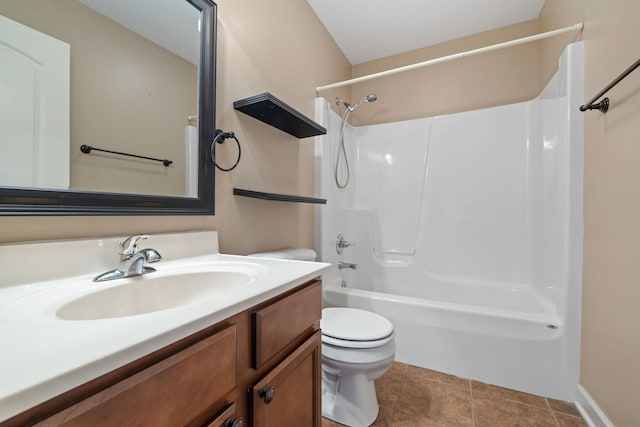 full bathroom featuring washtub / shower combination, tile patterned floors, vanity, and toilet