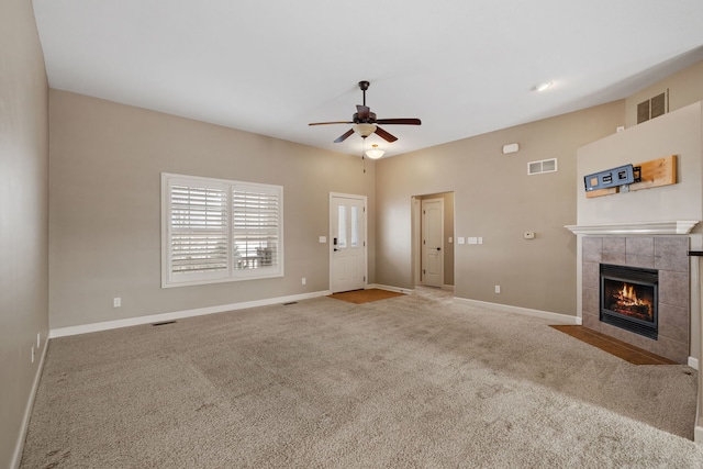 unfurnished living room with a fireplace, carpet floors, and ceiling fan