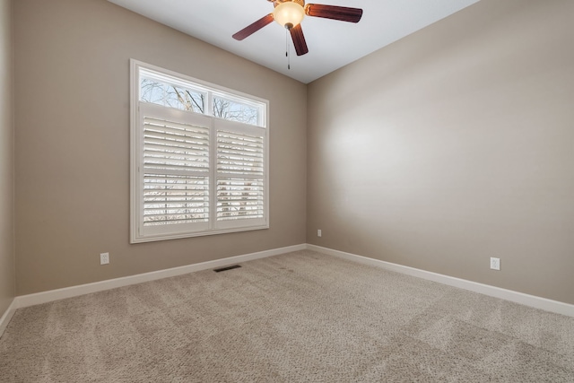 carpeted spare room with ceiling fan