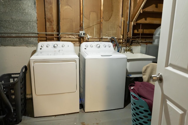 clothes washing area featuring washer and dryer and sink