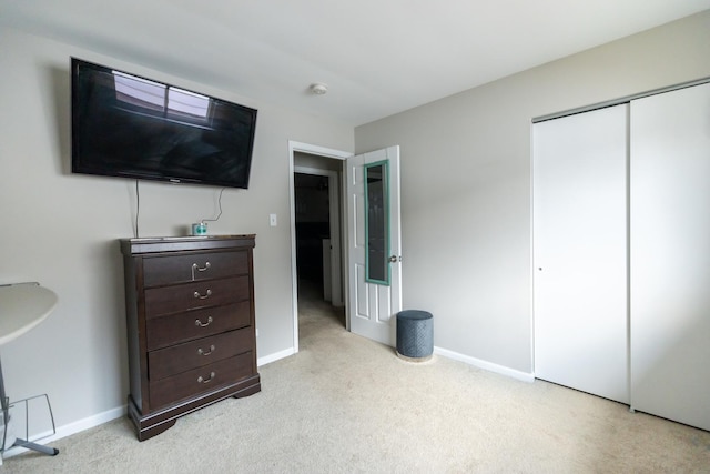 bedroom with a closet and light colored carpet