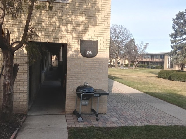 view of exterior entry with a yard