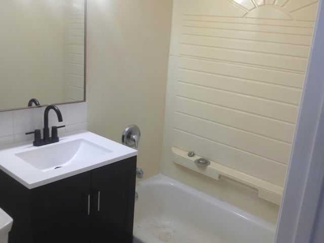 bathroom with decorative backsplash, shower / tub combination, and vanity