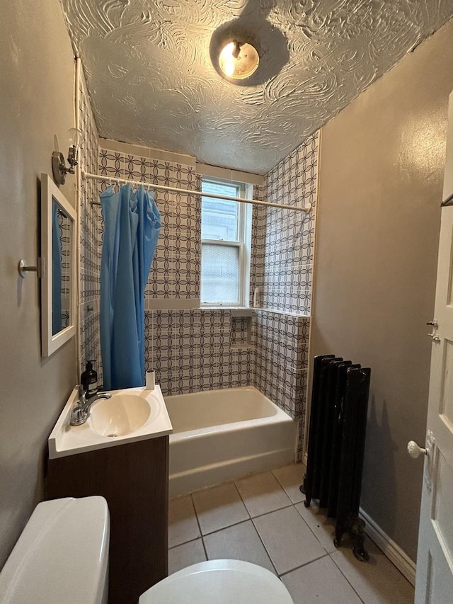 full bathroom with radiator, vanity, a textured ceiling, shower / bathtub combination with curtain, and tile patterned flooring