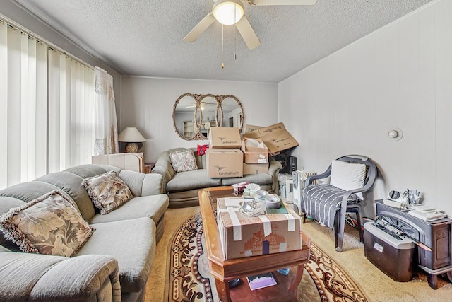 living room with a textured ceiling and ceiling fan