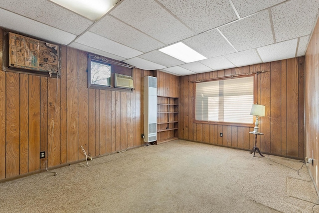 carpeted empty room with a drop ceiling