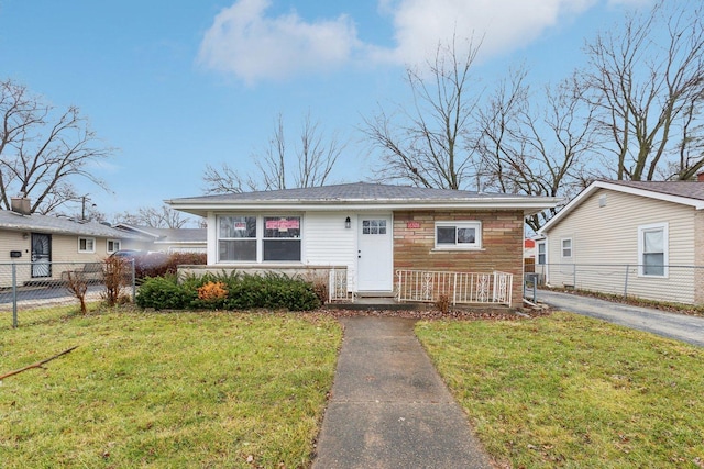 bungalow with a front yard and fence