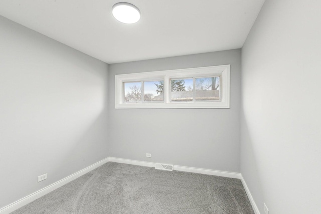 carpeted empty room with baseboards and visible vents