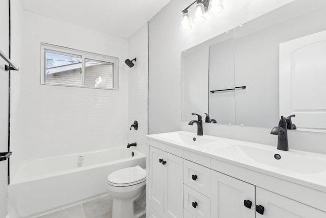 full bathroom with toilet, double vanity, washtub / shower combination, and a sink