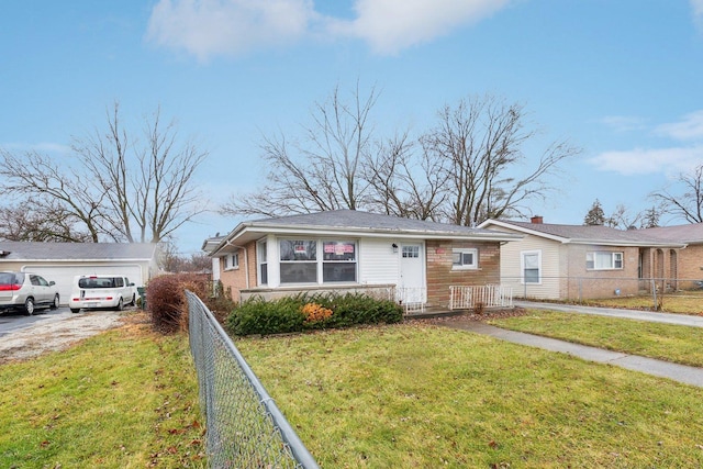 view of front of home with a front lawn, fence, and brick siding