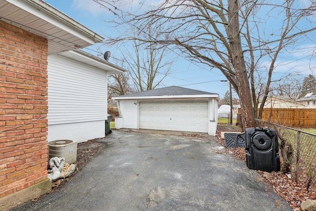 detached garage featuring fence