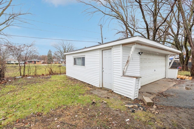 detached garage featuring fence