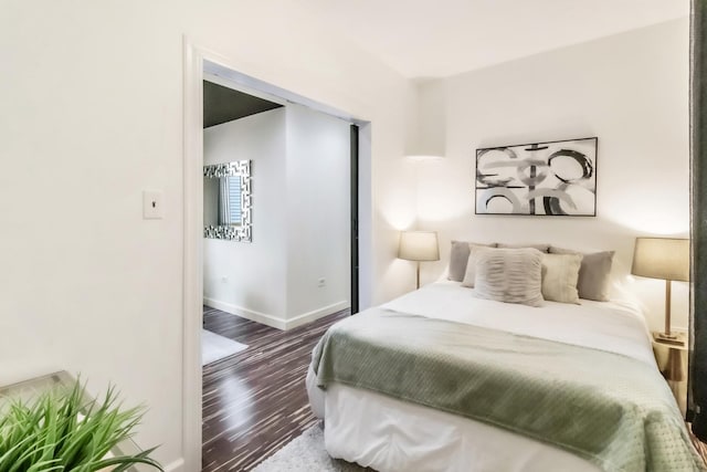 bedroom with dark hardwood / wood-style floors