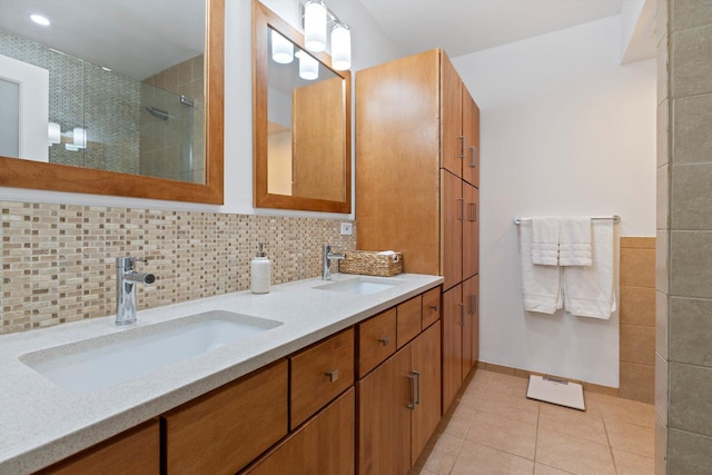 bathroom with tile patterned floors, vanity, and tasteful backsplash