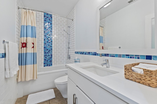 full bathroom featuring tile patterned floors, vanity, shower / bathtub combination with curtain, tile walls, and toilet