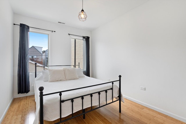 bedroom with hardwood / wood-style flooring