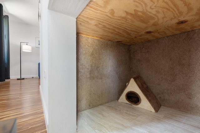 interior space featuring hardwood / wood-style flooring and wood ceiling