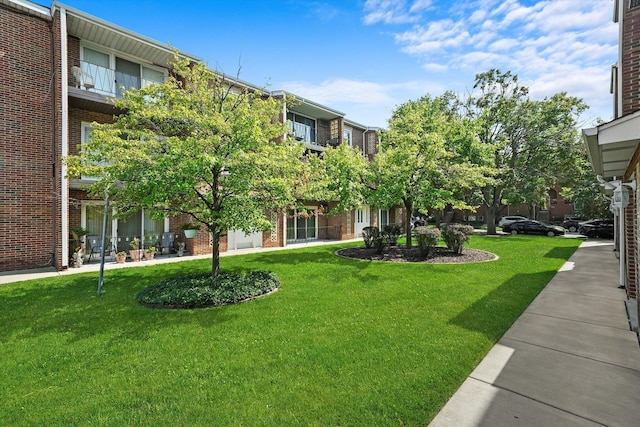 view of home's community with a lawn