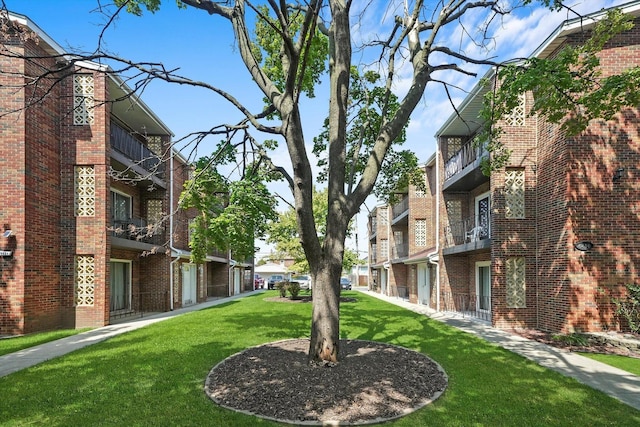 view of home's community featuring a lawn