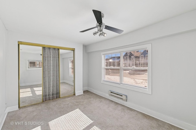 unfurnished bedroom featuring light carpet, a closet, and ceiling fan