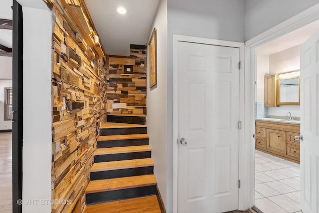 staircase with sink and tile patterned flooring