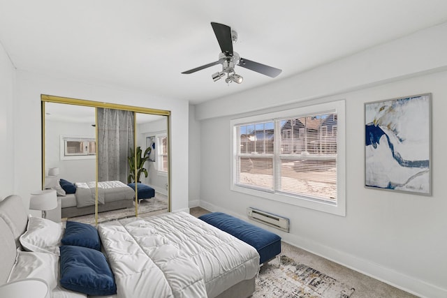 carpeted bedroom featuring ceiling fan and a closet