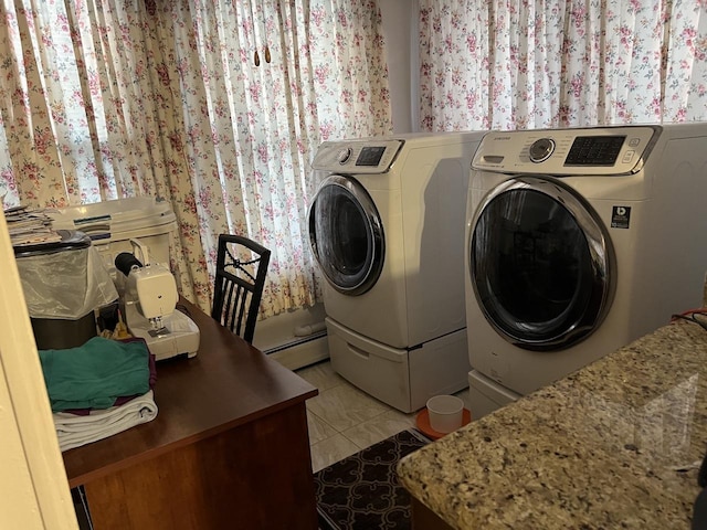 laundry area featuring washer and dryer, light tile patterned floors, and a baseboard radiator