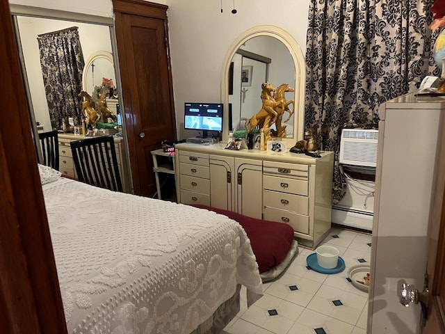 bedroom featuring a wall mounted air conditioner, light tile patterned floors, and a baseboard radiator