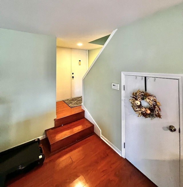 staircase featuring hardwood / wood-style flooring