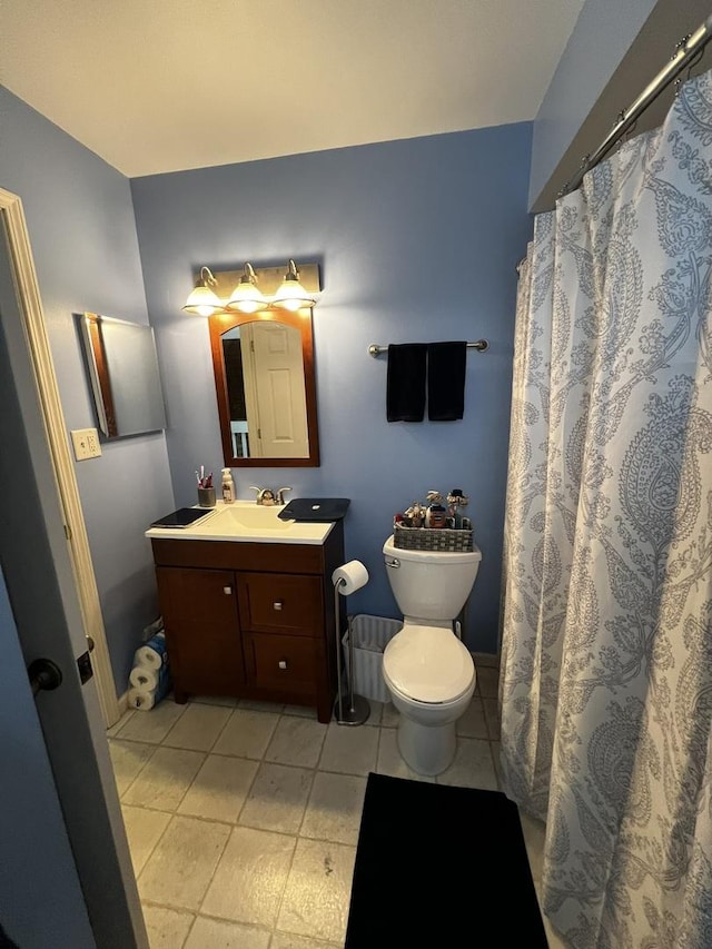 bathroom with tile patterned floors, vanity, and toilet