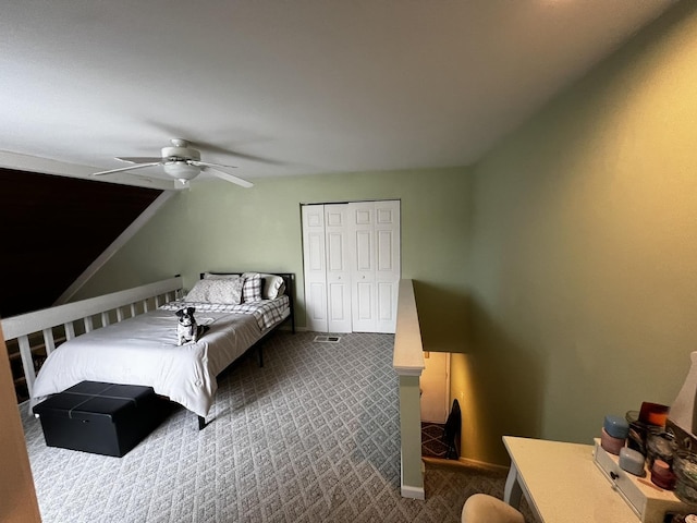 carpeted bedroom with ceiling fan and a closet