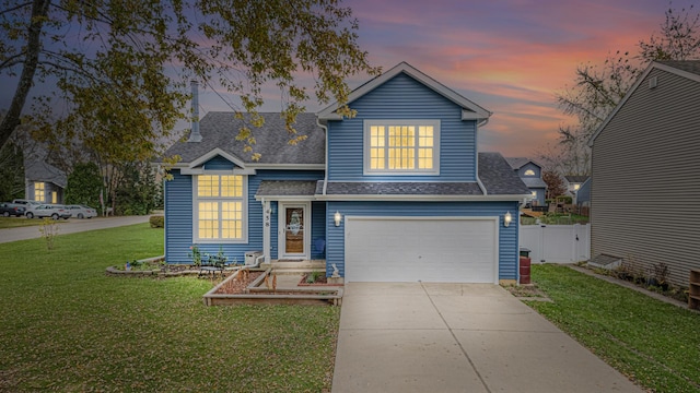 view of front of house featuring a lawn and a garage