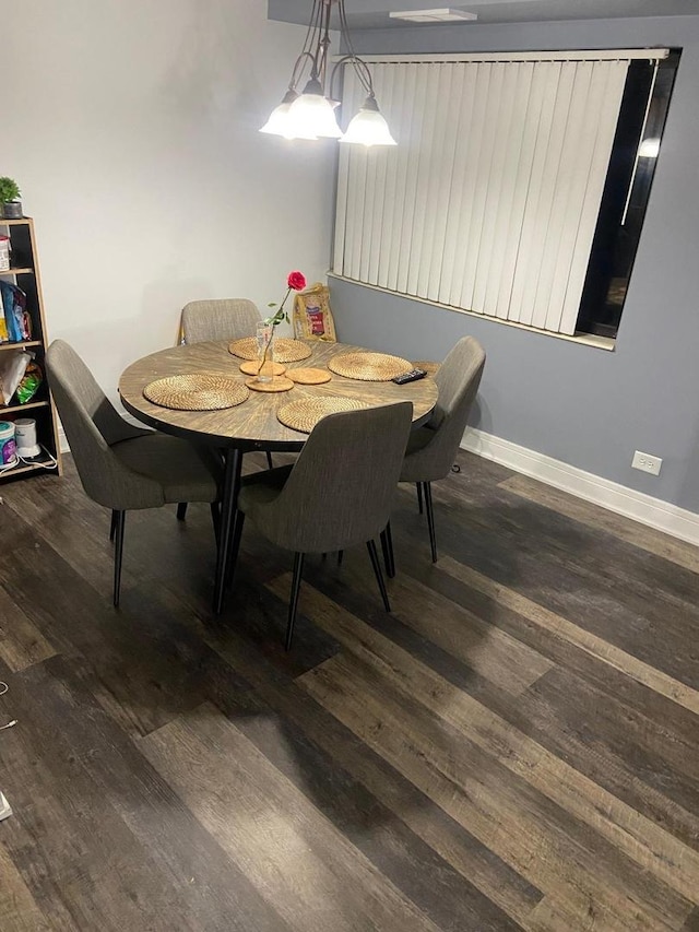 dining space featuring dark wood-type flooring